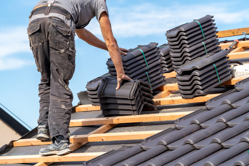 Roofer installing tiles